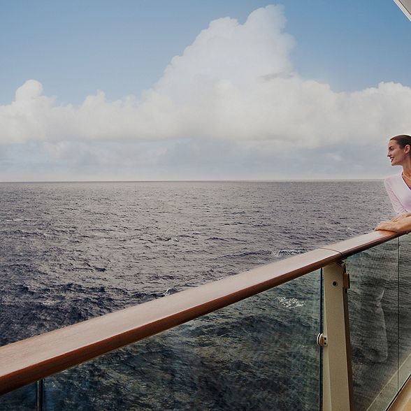 Couple looking out on the ocean on a cruise balcony