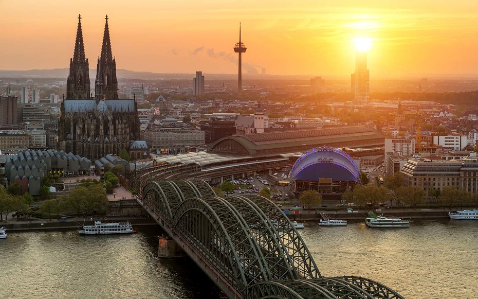Cologne Cathedral and Rhine river during sunset in Cologne, Germany.